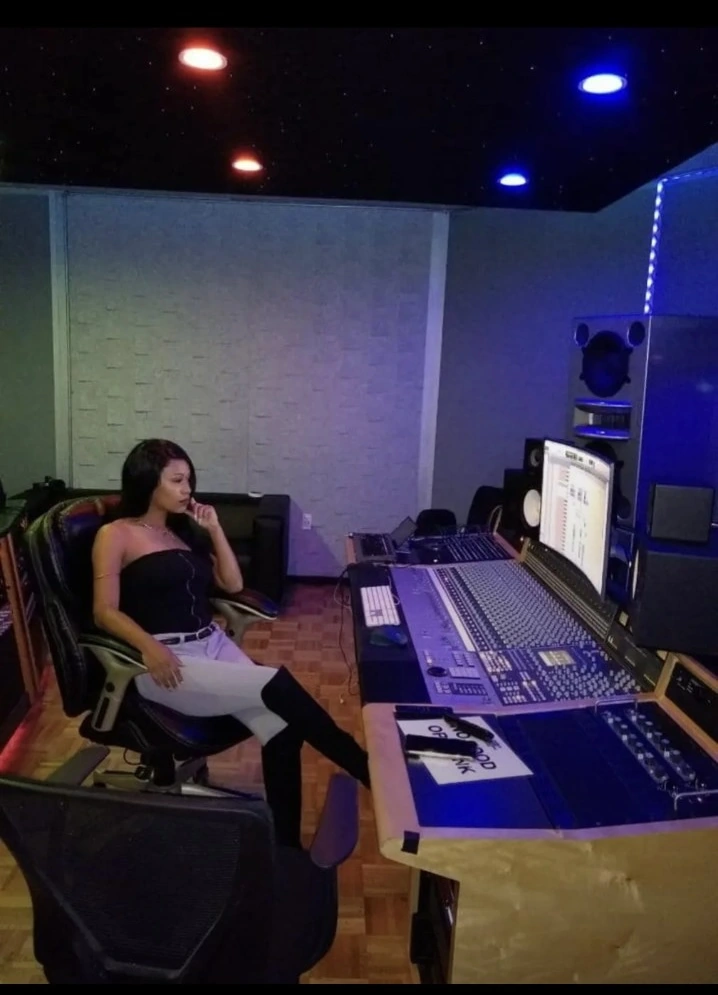 B’Chelle working at a recording studio mixing console